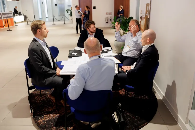 Mining industry professionals discussing opportunities during a group meeting at 121 London