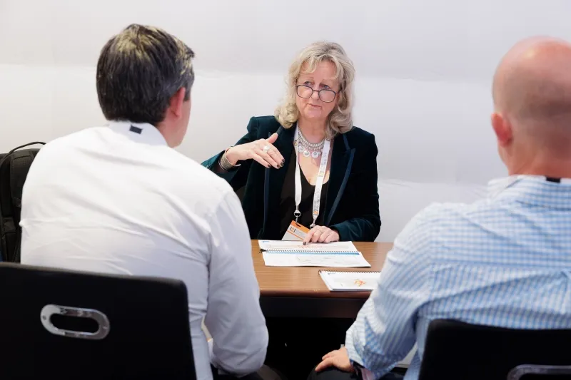 Investor discussing mining opportunities with company representatives at 121 London